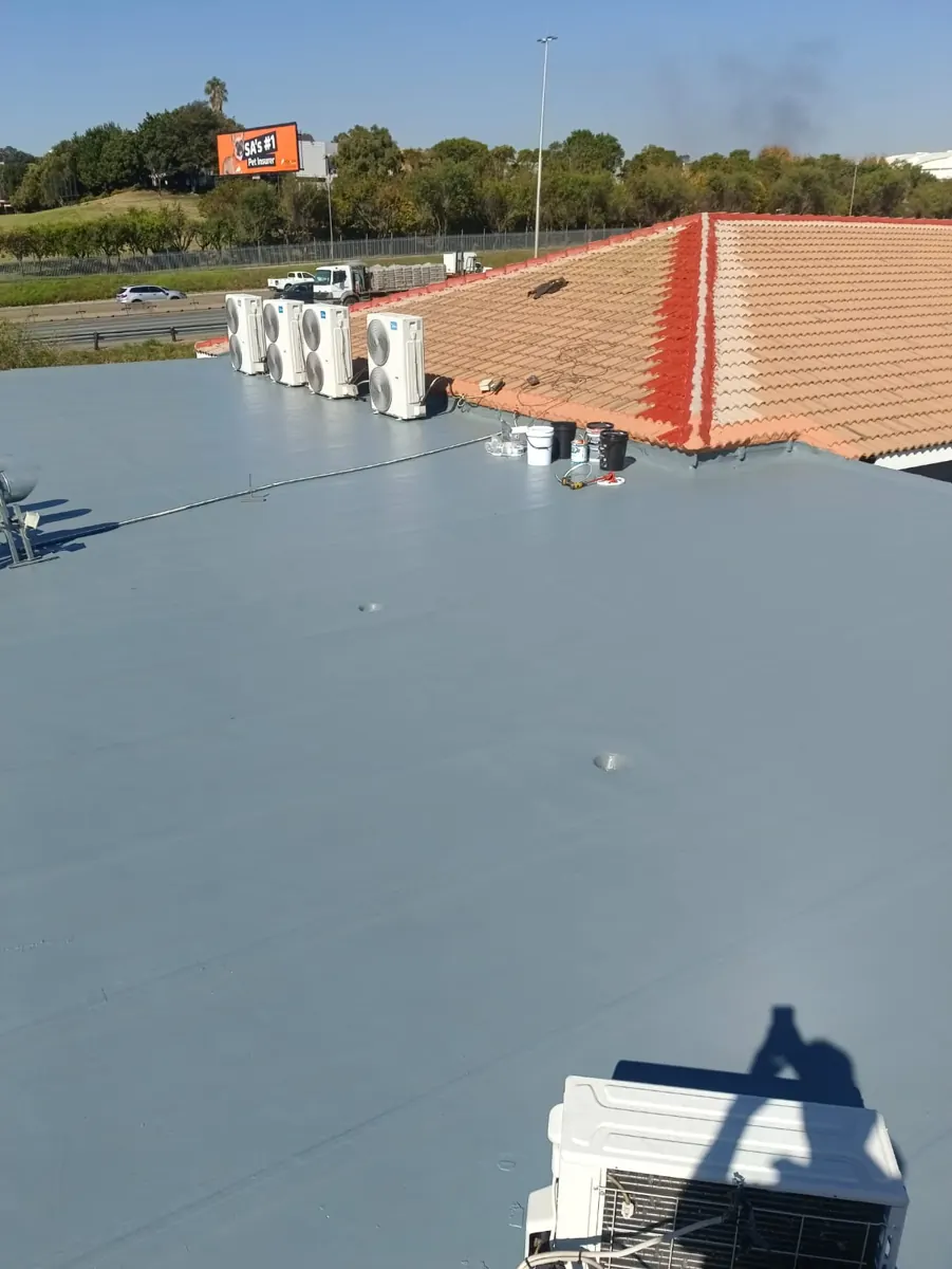 Flat roof sealed with Just Rubber solvent-based coating over torch-on